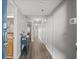 Hallway features wood flooring, neutral paint, and tasteful decorations in condo at 4800 S Ocean Blvd. # 420, North Myrtle Beach, SC 29582