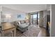 Living room with a sleeper sofa and ocean view balcony access at 4800 S Ocean Blvd. # 420, North Myrtle Beach, SC 29582