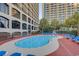 Refreshing outdoor pool with poolside seating and lush landscaping, perfect for relaxation at 4800 S Ocean Blvd. # 420, North Myrtle Beach, SC 29582