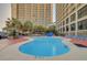 Relaxing outdoor pool surrounded by palm trees and comfortable lounge chairs, ideal for unwinding at 4800 S Ocean Blvd. # 420, North Myrtle Beach, SC 29582