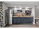 Wet bar features stainless steel refrigerator, microwave, and a tiled backsplash at 4800 S Ocean Blvd. # 420, North Myrtle Beach, SC 29582