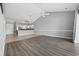 Open-concept living area with vaulted ceilings, wood-look flooring, and seamless transition to a modern kitchen at 4860 Carnation Circle # 302, Myrtle Beach, SC 29577