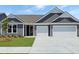 Charming one-story home featuring gray siding, a well-manicured lawn, and a spacious three-car garage at 531 Oak Landing Dr., Myrtle Beach, SC 29588