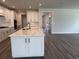 Bright, open kitchen featuring a large island, white cabinets, and modern black fixtures with views of the living area at 531 Oak Landing Dr., Myrtle Beach, SC 29588
