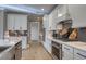 Modern kitchen with white cabinetry, sleek countertops, and stainless steel appliances at 531 Oak Landing Dr., Myrtle Beach, SC 29588