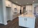 Modern kitchen with white cabinets, a large island, granite countertops, and stainless steel appliances at 531 Oak Landing Dr., Myrtle Beach, SC 29588