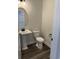 Modern powder room featuring a pedestal sink, black fixtures, and wood flooring at 531 Oak Landing Dr., Myrtle Beach, SC 29588