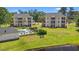 Scenic aerial view of two condo buildings with a nearby pool, lush landscaping, and water feature at 545 White River Dr. # 15 D, Myrtle Beach, SC 29579