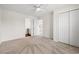 Bright bedroom featuring neutral carpet, ceiling fan, and closet for ample storage at 545 White River Dr. # 15 D, Myrtle Beach, SC 29579