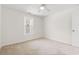Bright bedroom showcasing neutral carpet, a ceiling fan, and a window letting in natural light at 545 White River Dr. # 15 D, Myrtle Beach, SC 29579
