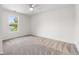 Bedroom featuring neutral carpet, ceiling fan, and bright window view to outside scenery at 545 White River Dr. # 15 D, Myrtle Beach, SC 29579