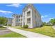 Condo building with multiple stories, white balconies, and a well-maintained lawn at 545 White River Dr. # 15 D, Myrtle Beach, SC 29579