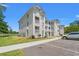 Well-maintained condo buildings with parking, sidewalks, and manicured landscaping on a clear, sunny day at 545 White River Dr. # 15 D, Myrtle Beach, SC 29579