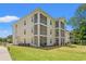 Multi-story condo building featuring screened-in porches and manicured landscaping at 545 White River Dr. # 15 D, Myrtle Beach, SC 29579