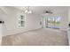 Bright living room with a sliding glass door with outdoor view, and an elegant light fixture at 545 White River Dr. # 15 D, Myrtle Beach, SC 29579