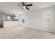 Spacious living room with neutral carpet, modern ceiling fan and kitchen view at 545 White River Dr. # 15 D, Myrtle Beach, SC 29579