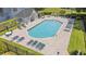 Beautiful pool area featuring lounge chairs, tables, manicured landscaping, and a nearby pool house at 545 White River Dr. # 15 D, Myrtle Beach, SC 29579