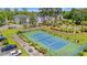 Aerial view of a tennis court surrounded by well-maintained landscaping, buildings, and parking areas at 545 White River Dr. # 15 D, Myrtle Beach, SC 29579