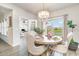 Elegant dining room with hardwood floors, chandelier lighting, and views of the pond through the large windows at 567 Hickman St., Surfside Beach, SC 29575