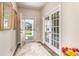 Inviting entryway with decorative mirror, neutral walls, and view to the outdoors at 567 Hickman St., Surfside Beach, SC 29575