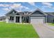 Charming home with blue siding, well-manicured lawn, and attached two-car garage at 567 Hickman St., Surfside Beach, SC 29575