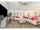 Spacious living room with hardwood floors, large windows offering natural light, and comfortable sectional sofa at 567 Hickman St., Surfside Beach, SC 29575