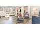 Well-lit living room with hardwood floors, modern furniture, and an open layout to the adjacent living spaces at 567 Hickman St., Surfside Beach, SC 29575