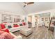 Bright living room featuring hardwood floors, vaulted ceilings, and an open floor plan leading to the kitchen at 567 Hickman St., Surfside Beach, SC 29575