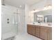 Bright bathroom featuring double sinks, a large shower with glass door and white tiled walls at 567 Hickman St., Surfside Beach, SC 29575