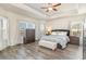 Spacious bedroom features tray ceilings, abundant natural light, and wood-look flooring at 567 Hickman St., Surfside Beach, SC 29575
