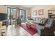 Comfortable living room featuring a sofa, armchair, TV, and access to a balcony at 5905 South Kings Hwy. # 131B, Myrtle Beach, SC 29575