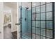 Modern tile shower with glass enclosure and black trim, creating a luxurious and stylish bathroom experience at 605 62Nd Ave. N, Myrtle Beach, SC 29572