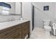 Updated bathroom with wood vanity, marble countertop, and modern fixtures at 605 62Nd Ave. N, Myrtle Beach, SC 29572