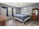 Cozy bedroom with grey walls, wood-look floors, and natural light from a window at 605 62Nd Ave. N, Myrtle Beach, SC 29572