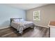 Bright bedroom with wood-look floors, a double bed, and a window creating a peaceful retreat with plenty of natural light at 605 62Nd Ave. N, Myrtle Beach, SC 29572