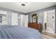 Neutral bedroom showcasing wood-look floors, ceiling fan, and soft blue bedding at 605 62Nd Ave. N, Myrtle Beach, SC 29572