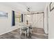 Charming dining area with wood-look floors, modern light fixture, a window with a view, and barn doors to closet at 605 62Nd Ave. N, Myrtle Beach, SC 29572