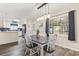 Inviting dining room featuring a window and modern light fixture, open to the kitchen with stylish decor and neutral colors at 605 62Nd Ave. N, Myrtle Beach, SC 29572