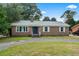 Charming brick home featuring a well-maintained front yard, inviting entrance, and classic architectural details at 605 62Nd Ave. N, Myrtle Beach, SC 29572