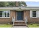 Inviting front entrance with brick steps, white railings, and a stylish front door flanked by sconces at 605 62Nd Ave. N, Myrtle Beach, SC 29572
