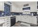 Stylish kitchen featuring white cabinets, sleek black appliances, and eye-catching blue backsplash at 605 62Nd Ave. N, Myrtle Beach, SC 29572