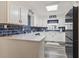 Bright kitchen with white cabinets, blue subway tile backsplash, and modern appliances at 605 62Nd Ave. N, Myrtle Beach, SC 29572