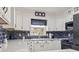 Modern kitchen featuring white cabinets, quartz countertops, and blue tile backsplash at 605 62Nd Ave. N, Myrtle Beach, SC 29572