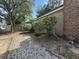 Landscaped backyard with a gravel area, shrubbery, and a brick chimney at 607 A 28Th Ave. S, North Myrtle Beach, SC 29582