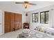 Comfortable bedroom with twin beds, wooden closet with louvered doors, adjacent to the vintage desk and windows at 607 A 28Th Ave. S, North Myrtle Beach, SC 29582