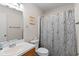 Bathroom with vanity sink, mirror, toilet and shower with patterned curtain at 607 A 28Th Ave. S, North Myrtle Beach, SC 29582