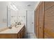 Bathroom with neutral countertop vanity, wooden cabinet and large closet at 607 A 28Th Ave. S, North Myrtle Beach, SC 29582