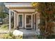 Inviting front porch with a clear glass door, side window, and decorative accents at 607 A 28Th Ave. S, North Myrtle Beach, SC 29582