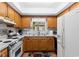 Bright kitchen with white appliances, neutral countertops, and wooden cabinets at 607 A 28Th Ave. S, North Myrtle Beach, SC 29582