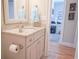 Bathroom featuring granite countertop, vanity, and a decorative mirror with view into office at 625 Whispering Pines Ct., Murrells Inlet, SC 29576